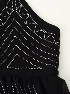 Macro view of geometric beadwork and sequins on black chiffon top with embroidery details