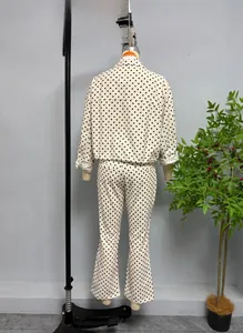 Rear view of cream-colored polka dot puff sleeve jacket and matching flared trousers set