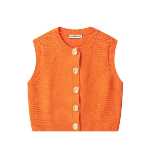 Detailed view of orange knitted vest with textured shell buttons and ribbed edges