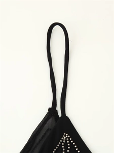 Detail of black camisole showing silver beadwork embroidery and thin elastic straps