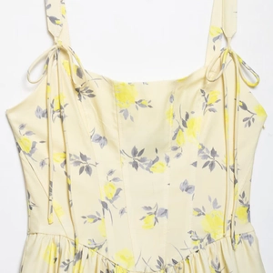Floral poplin mini dress with yellow rose print and adjustable tie shoulder straps