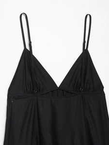 Detail of black V-neck midi dress featuring adjustable spaghetti straps and side zipper