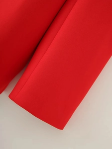 Detail of red blazer cuff showing high-quality fabric texture and neat stitching