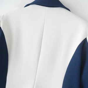 Detail of the navy and white color-block blazer showing back stitching and woven texture