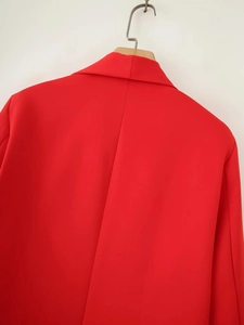 Close-up of the back seam detail on a vibrant red shawl collar blazer for women