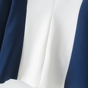 Detailed macro view of two-tone navy and white twill fabric with precision stitching