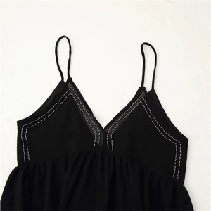Black V-neck camisole top with white bead embellishments and pleated chiffon fabric
