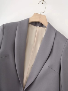 Detail of grey shawl collar blazer featuring smooth fabric and premium beige satin lining