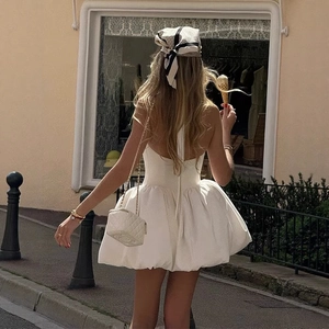 Detail of the white halter bubble dress showing open back design and puffy silhouette