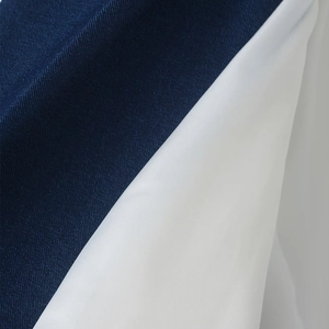 Detailed macro view of smooth navy blue and white diagonal twill fabric texture