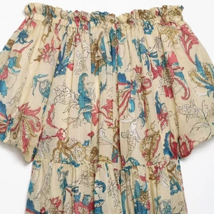 Floral print ramie off-shoulder summer dress with colorful ethnic patterns on beige fabric