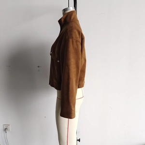 Detail of caramel brown faux suede jacket featuring high collar and drop shoulder design