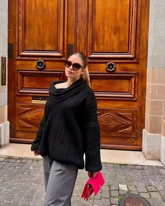 Detail of black chunky knit oversized sweater featuring vertical texture and slouchy fit