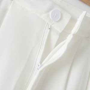 Detail of white four-hole button, invisible zipper, and twill fabric texture on elegant suit
