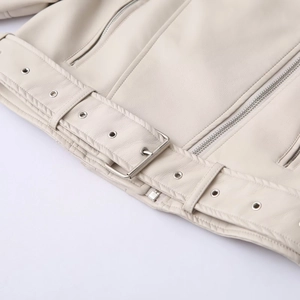Detail of faux leather biker jacket featuring a belted hem with silver metal buckle
