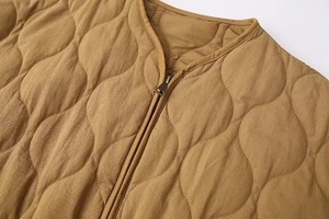 Detail of wave quilted washed cotton jacket featuring vintage metal zipper and V-neckline