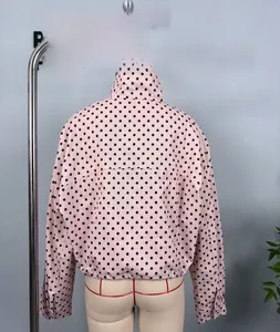Rear view of pink polka dot bubble gauze jacket featuring a stand collar and elastic hem