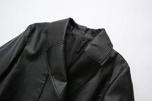 Detail view of black faux leather jacket lapel and shoulder stitching quality