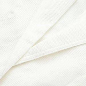 White waffle weave texture detail of high-quality loose fitting coat for women