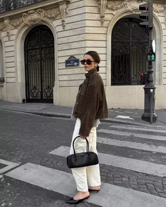 Detailed close-up of a brown suede cropped jacket with street style fashion aesthetic