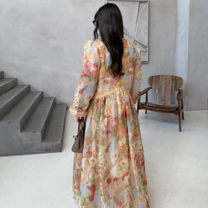 Vintage floral maxi dress with puff sleeves and lace trim in warm orange print
