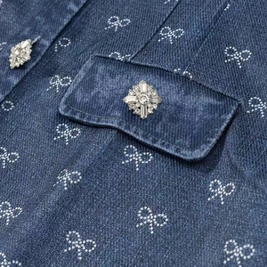 Dark blue denim dress featuring all-over rhinestone bow patterns and crystal buttons