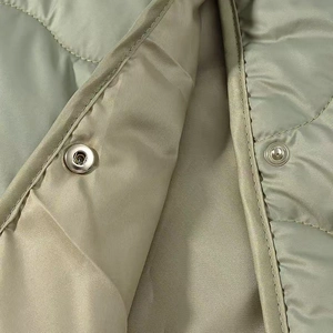 Women's light olive green quilted jacket with crew neck and diamond stitch patterns