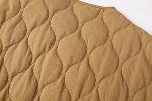 Close-up of onion quilted wash cotton jacket showing fine stitching and wavy patterns