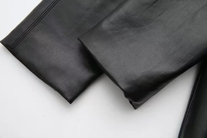 Detailed close-up of high-quality black faux leather texture and premium stitching
