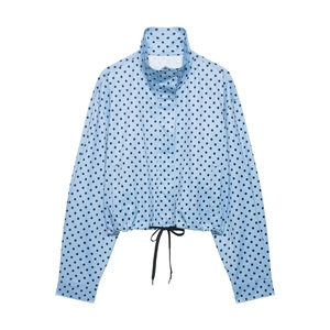 Detailed view of women's light blue polka dot bomber jacket with adjustable drawstring hem