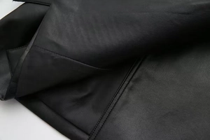 Detailed close-up of premium black faux leather texture with durable double-row stitching