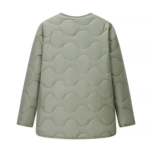 Detail of sage green quilted jacket featuring back view with wavy stitching and curved hem