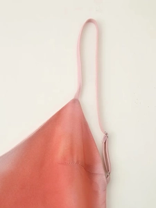Vue détaillée de la bretelle réglable sur le tissu en satin rose effet tie-dye