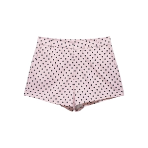 Close-up of pink polka dot shorts featuring a zip fly and belt loops on fabric