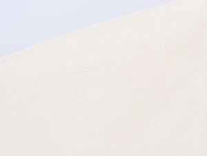 Close-up detail of beige linen fabric texture showing natural weave and soft drape
