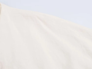 Detail shot of shoulder seams and neckline on embroidered linen kimono style shirt