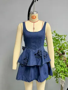 Detailed view of 3D denim flower applique on a dark blue sleeveless sundress