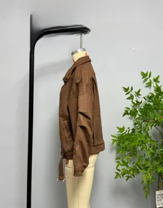 Detail view of brown faux suede casual jacket featuring classic collar and shoulder tabs