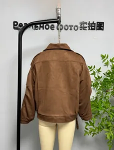 Detail of brown faux suede jacket featuring dropped shoulders and adjustable hem straps