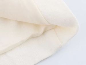 Detailed close-up of ivory linen fabric texture and high-quality lining stitching