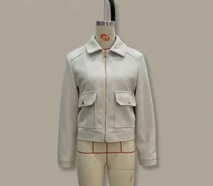 Detail of off-white tweed jacket featuring golden zipper and front square flap pockets