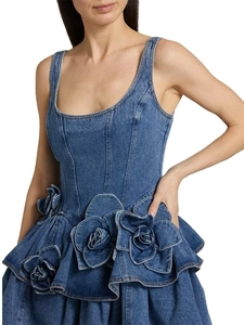 Close-up of 3D floral appliques and ruffled denim details on this dark blue dress