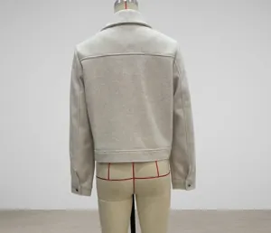 Rear view of cream-colored tweed cropped jacket with collar and hem details