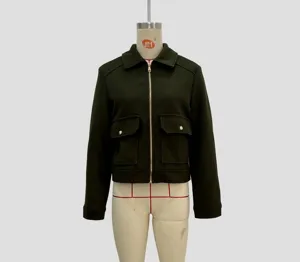 Detail of dark green tweed jacket featuring front metal zipper and large flap pockets