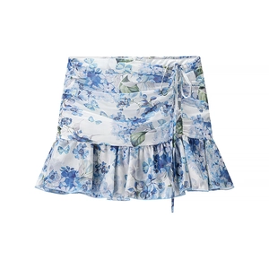 Women's blue floral mini skirt with ruffled hem and side tie details on white background
