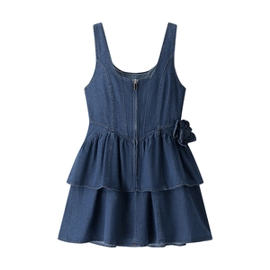 Detail of blue denim dress featuring 3D flower accent and metallic zipper closure