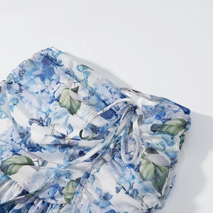 Detail view of blue floral chiffon fabric with adjustable drawstring and S size tag