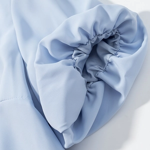 Detailed macro shot of light blue elasticated ruffled cuffs with precise stitching