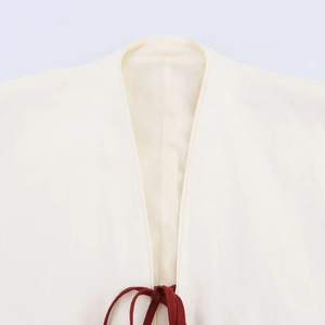 Ivory linen kimono jacket with deep red tie closure and delicate embroidered texture