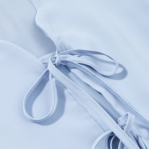 Close-up detail of light blue skirt set featuring drawstring waist and ruffled hem texture